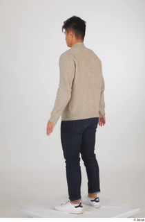 Yoshinaga Kuri blue jeans brown sweater casual dressed standing white…